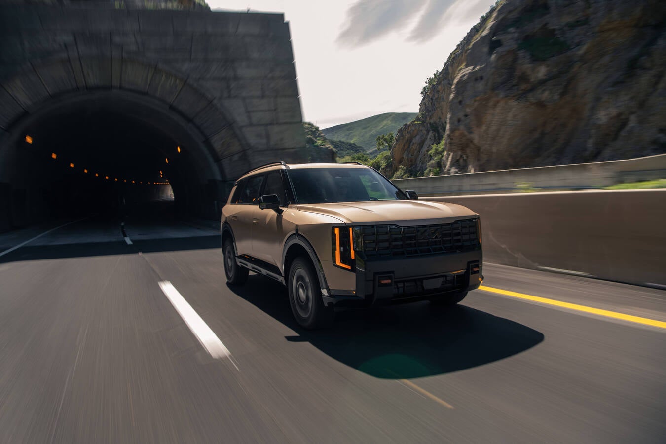 2027 Kia Telluride driving toward a tunnel