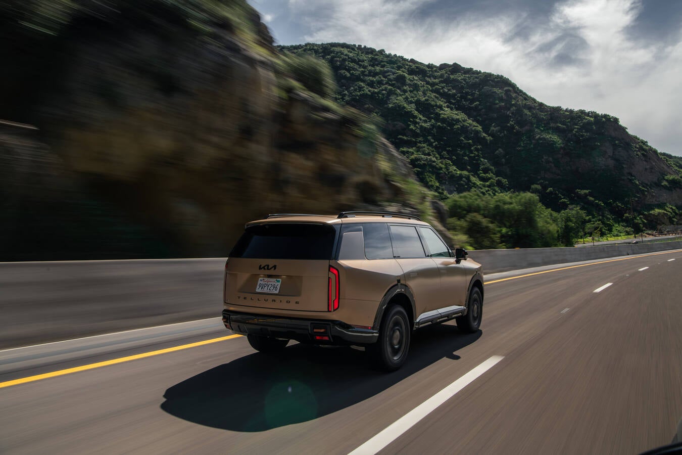 Rear view of 2027 Kia Telluride near trees